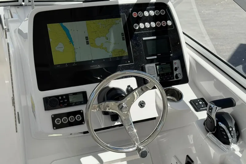 Slide: The Image of 2026 Edgewater 248CX Crossover boat dashboard with navigation display and controls. - 19