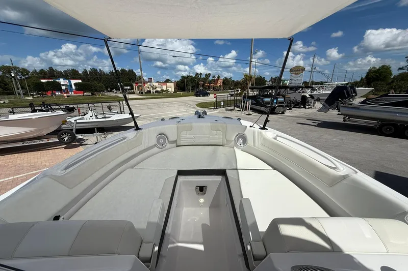 Slide: The Image of 2026 Edgewater 248CX Crossover boat interior with spacious seating under a sunny sky. - 22