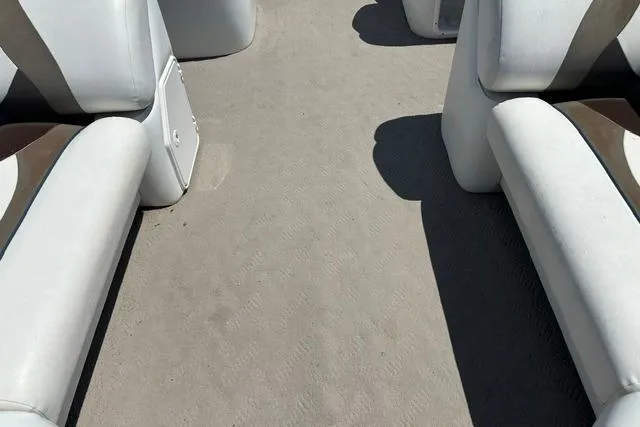 Slide: The Image of Interior view of a 2013 JC 23 Neptoon TT boat with white seating. - 12