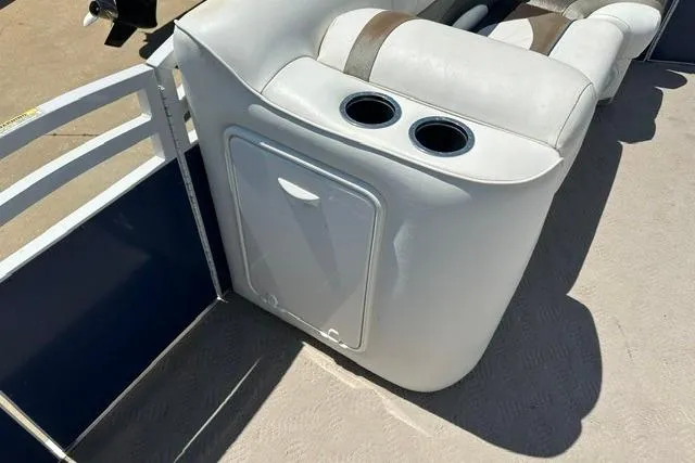 Slide: The Image of 2013 JC 23 Neptoon TT boat interior with cushioned seating and cup holders. - 14