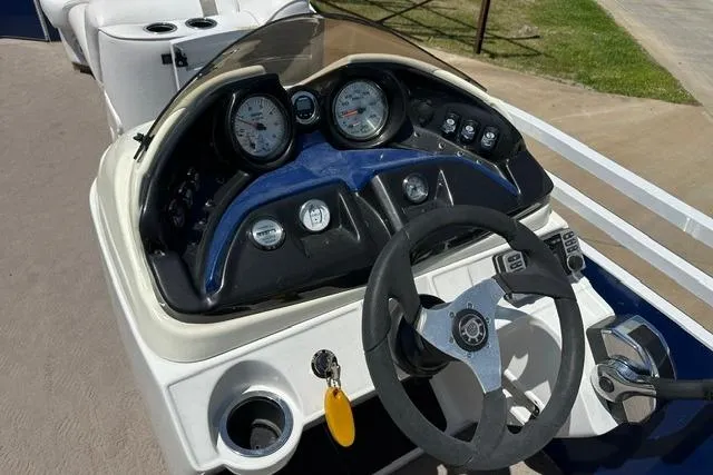 Slide: The Image of Steering console of a 2013 JC 23 Neptoon TT boat with gauges and controls. - 19
