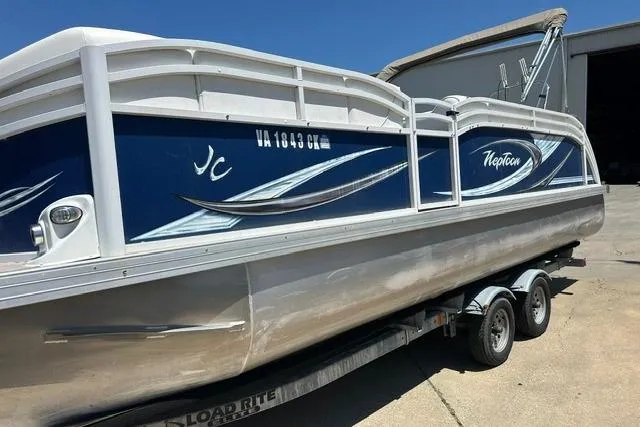 Slide: The Image of 2013 JC 23 Neptoon TT pontoon boat on trailer, blue and white design. - 2