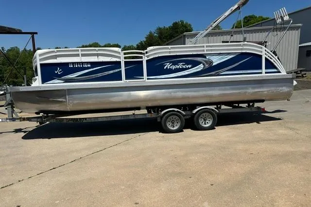 Slide: The Image of 2013 JC 23 Neptoon TT pontoon boat on trailer, parked outdoors. - 3