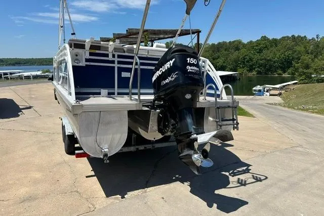 Slide: The Image of 2013 JC 23 Neptoon TT pontoon boat with Mercury 150 outboard motor on trailer. - 5