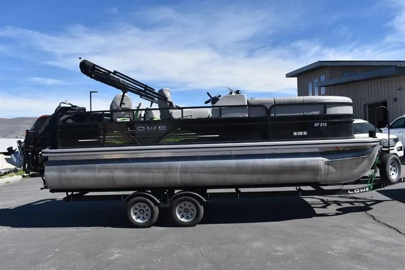 Slide: The Image of 2022 Lowe SF 212 Sport Fish pontoon boat on trailer, parked outdoors. - 10