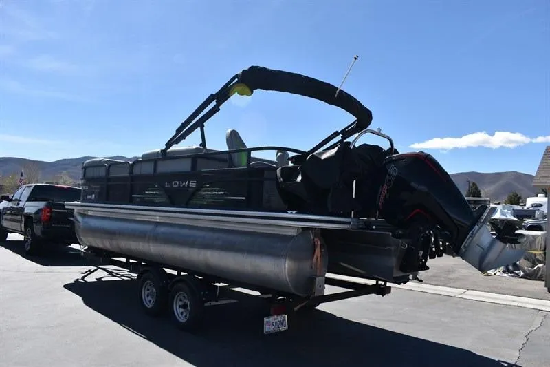 Slide: The Image of 2022 Lowe SF 212 Sport Fish pontoon boat on trailer, parked outdoors. - 11