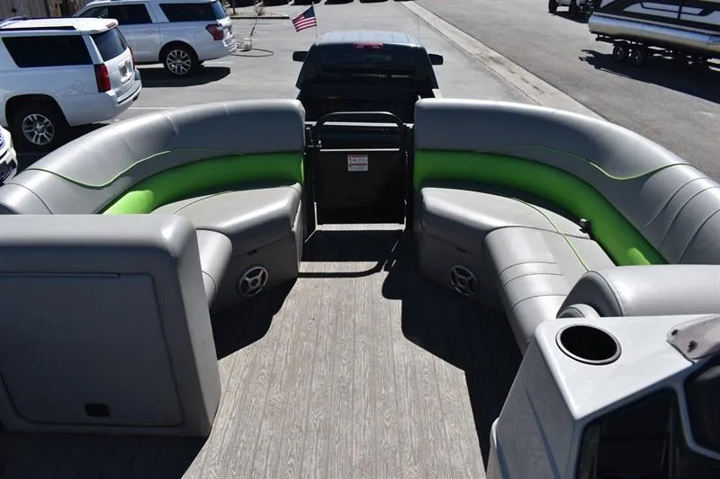 Slide: The Image of 2022 Lowe SF 212 Sport Fish pontoon boat with gray and green seating, parked on trailer. - 16