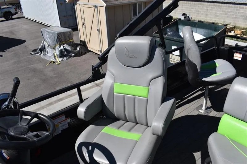 Slide: The Image of 2022 Lowe SF 212 Sport Fish boat seats with gray and green accents, docked outdoors. - 19