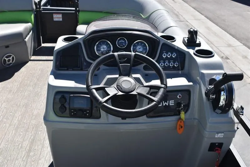 Slide: The Image of 2022 Lowe SF 212 Sport Fish boat dashboard with steering wheel and controls. - 23