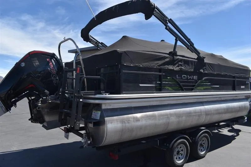 Slide: The Image of 2022 Lowe SF 212 Sport Fish pontoon boat with black canopy and outboard motor. - 4