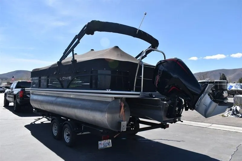 Slide: The Image of 2022 Lowe SF 212 Sport Fish pontoon boat on trailer, parked outdoors. - 5
