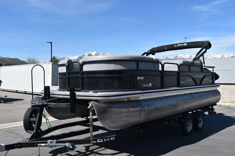 Slide: The Image of 2022 Lowe SF 212 Sport Fish pontoon boat on trailer, parked outdoors. - 7