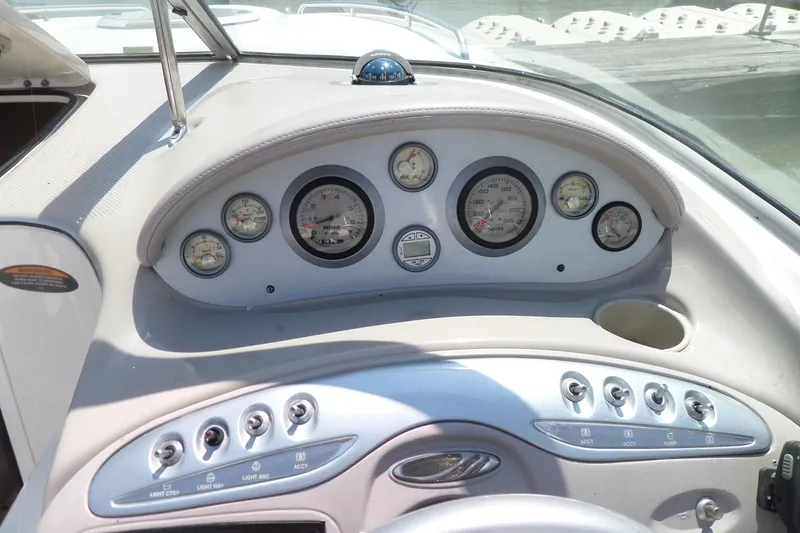 Slide: The Image of Dashboard of a 2003 Maxum 2400 SC boat with gauges and controls. - 10