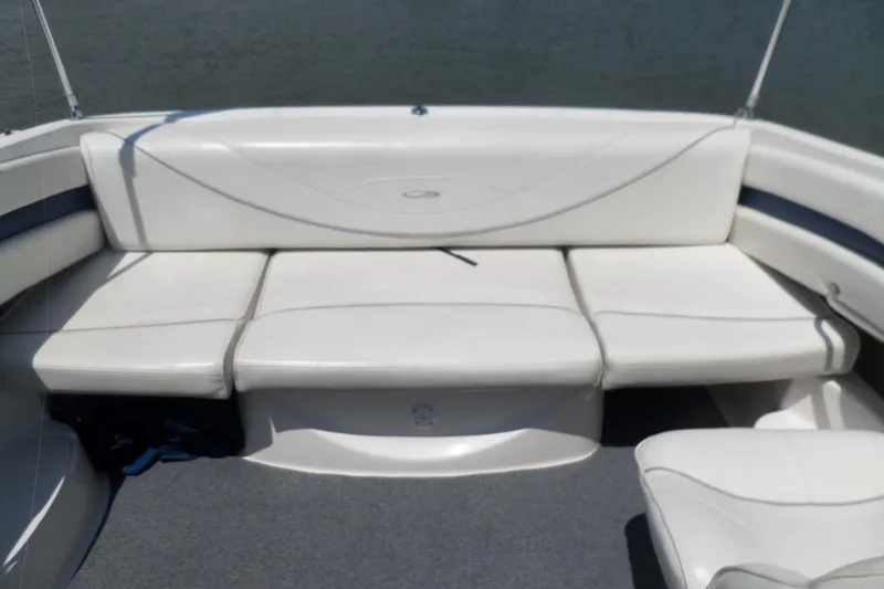 Slide: The Image of 2003 Maxum 2400 SC boat interior with white cushioned seating and gray flooring. - 19