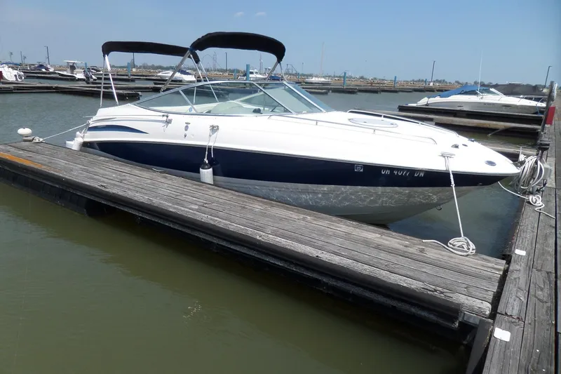 Slide: The Image of 2003 Maxum 2400 SC boat docked at marina on a sunny day. - 2