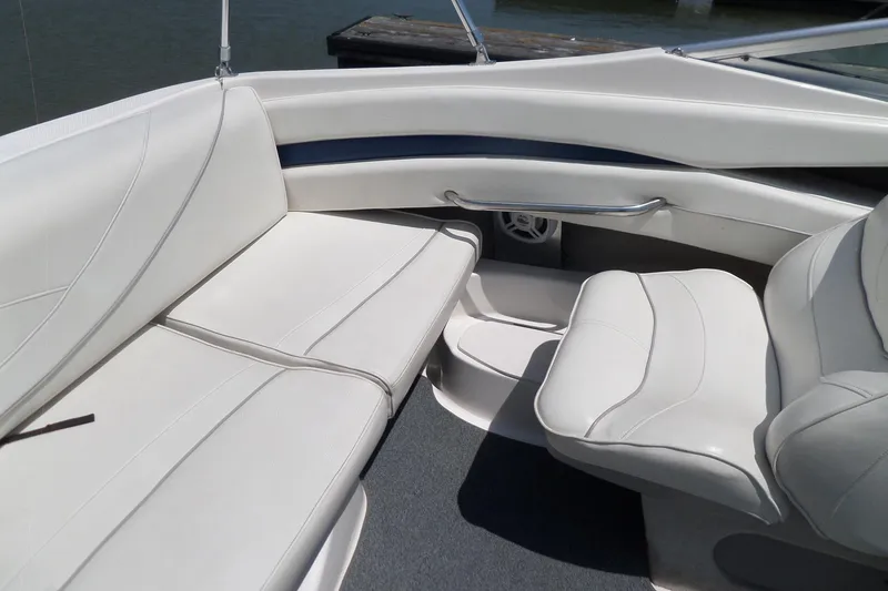 Slide: The Image of 2003 Maxum 2400 SC boat interior with white leather seating and sleek design. - 20
