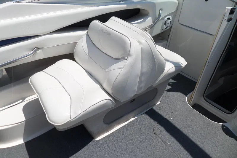 Slide: The Image of 2003 Maxum 2400 SC boat interior with white cushioned seating. - 21