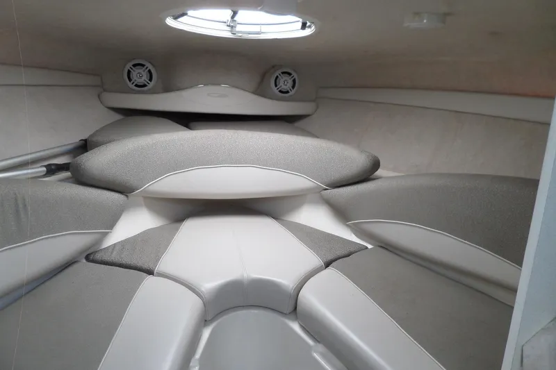 Slide: The Image of Interior cabin of a 2003 Maxum 2400 SC boat with cushioned seating. - 23
