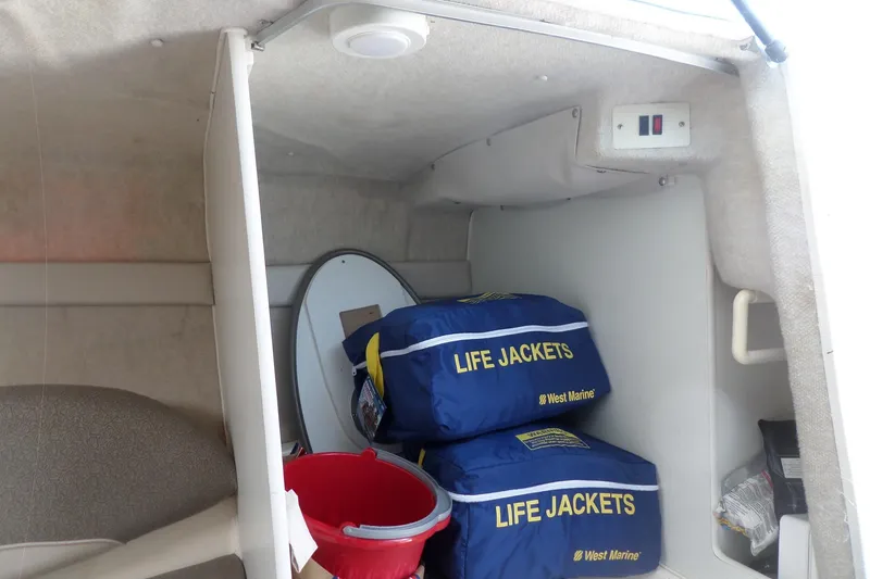 Slide: The Image of Interior of 2003 Maxum 2400 SC boat with life jackets and safety equipment. - 24