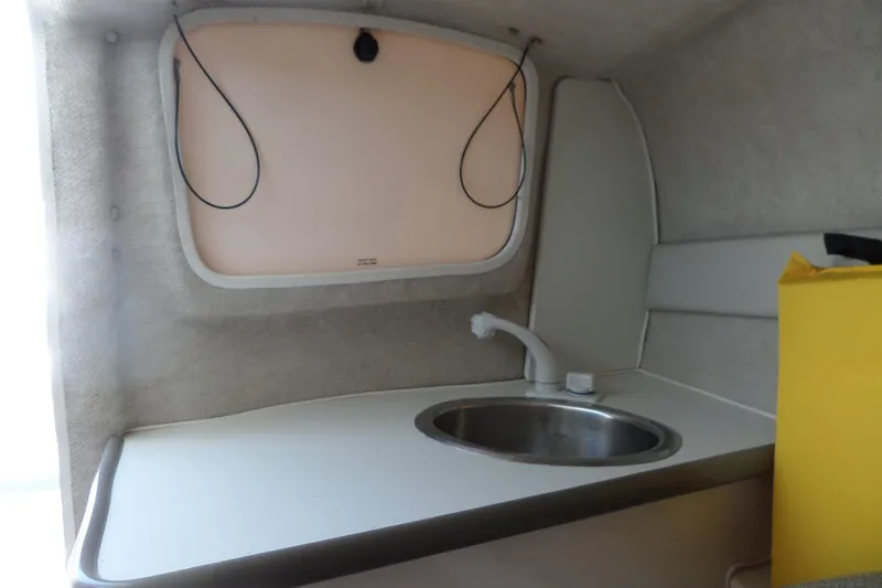 Slide: The Image of Compact kitchenette in 2003 Maxum 2400 SC boat with sink and window. - 26