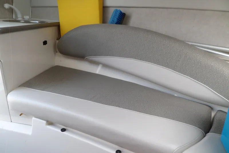 Slide: The Image of Interior seating of 2003 Maxum 2400 SC boat with sink and storage. - 28