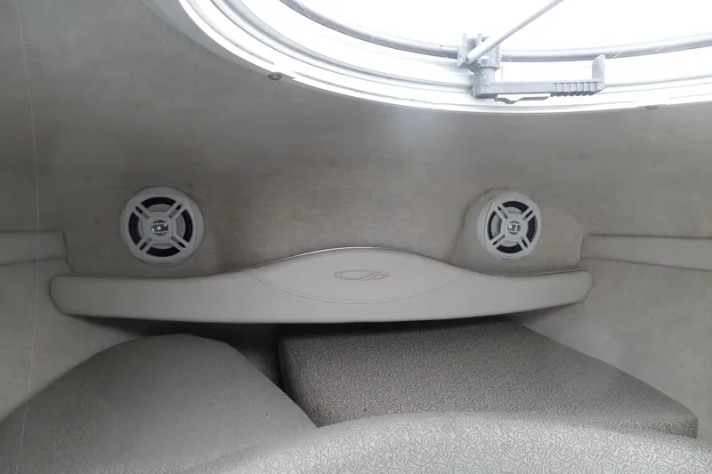 Slide: The Image of Interior cabin of 2003 Maxum 2400 SC boat with speakers and seating. - 31