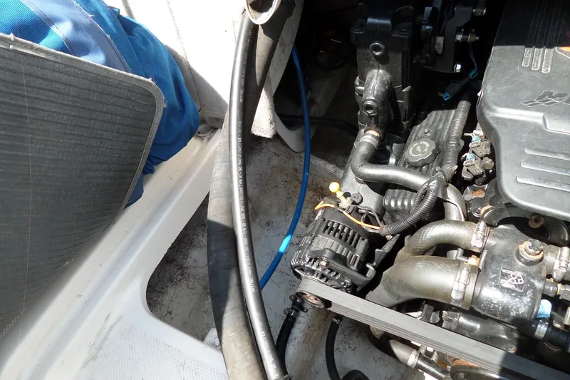 Slide: The Image of Engine compartment of a 2003 Maxum 2400 SC boat, showing hoses and components. - 33