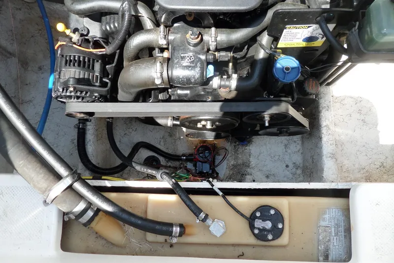 Slide: The Image of Engine compartment of a 2003 Maxum 2400 SC boat, showing detailed components and hoses. - 34