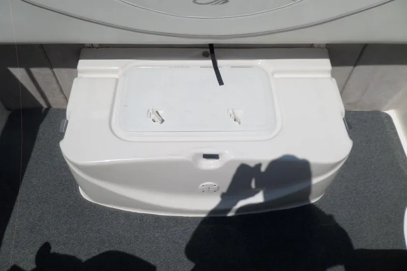 Slide: The Image of 2003 Maxum 2400 SC boat storage compartment with shadow on carpeted deck. - 36