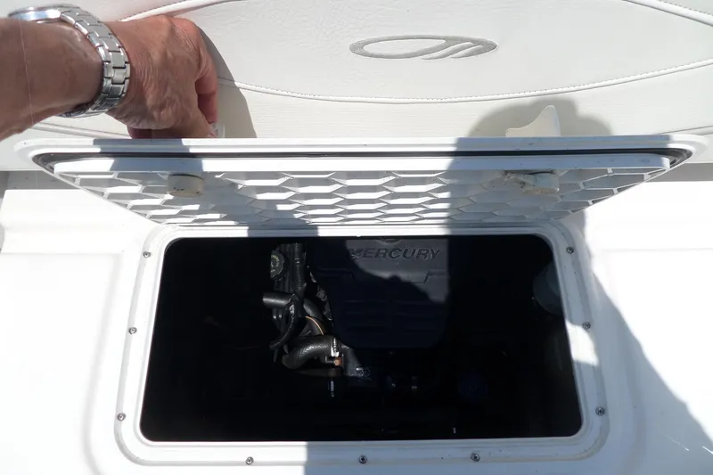 Slide: The Image of 2003 Maxum 2400 SC boat engine compartment with Mercury engine visible. - 37