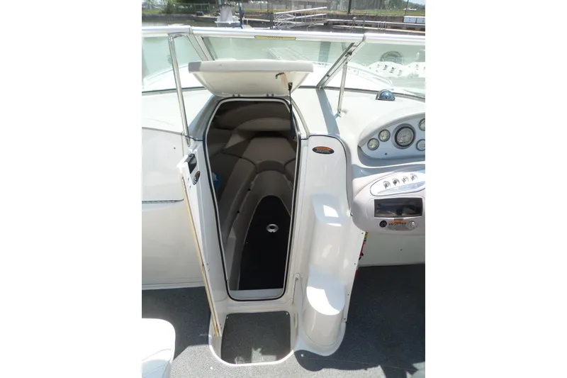 Slide: The Image of 2003 Maxum 2400 SC boat cabin entrance with open door and dashboard view. - 9
