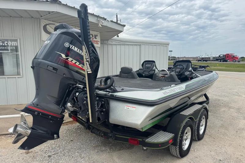 Slide: The Image of 2018 Skeeter ZX200 boat with Yamaha engine, parked on a trailer near a building. - 3