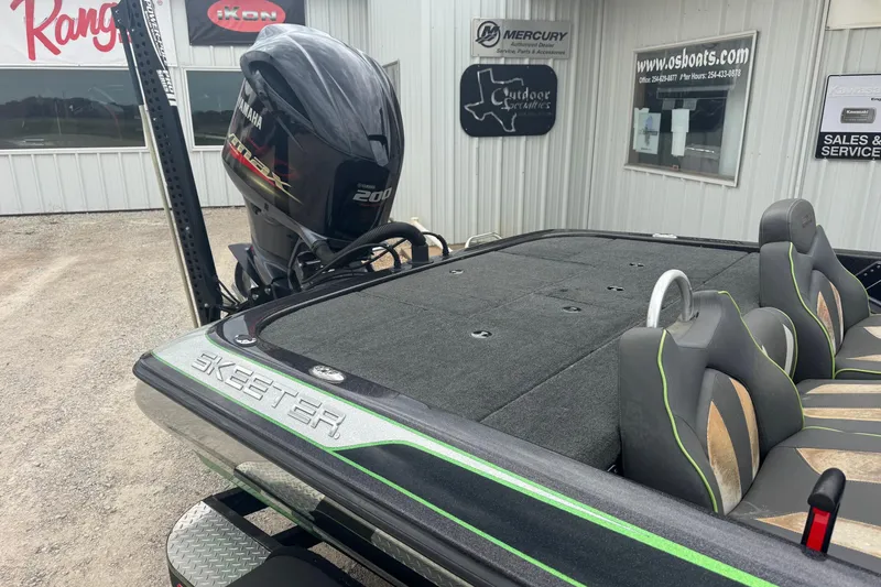 Slide: The Image of 2018 Skeeter ZX200 boat with Yamaha 200 engine, parked outside dealership. - 4