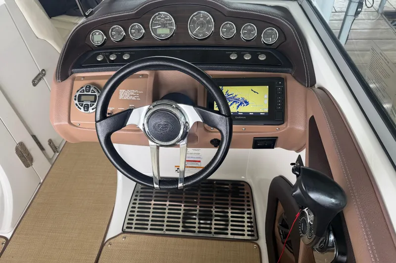 Slide: The Image of Dashboard of a 2012 Cobalt 242 boat with steering wheel and navigation system. - 10