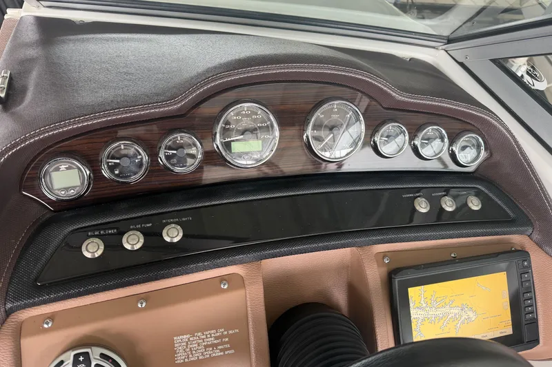 Slide: The Image of Dashboard of a 2012 Cobalt 242 boat with gauges and navigation system. - 12