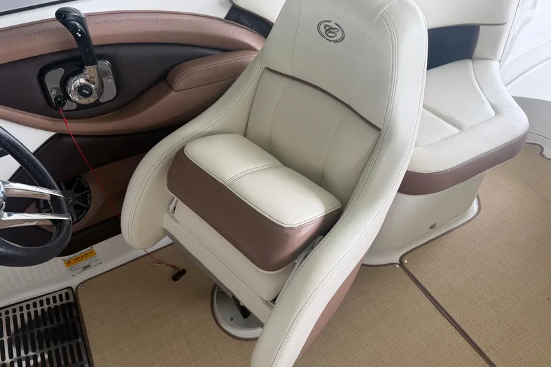 Slide: The Image of Luxury seating in a 2012 Cobalt 242 boat, featuring beige and brown upholstery. - 13