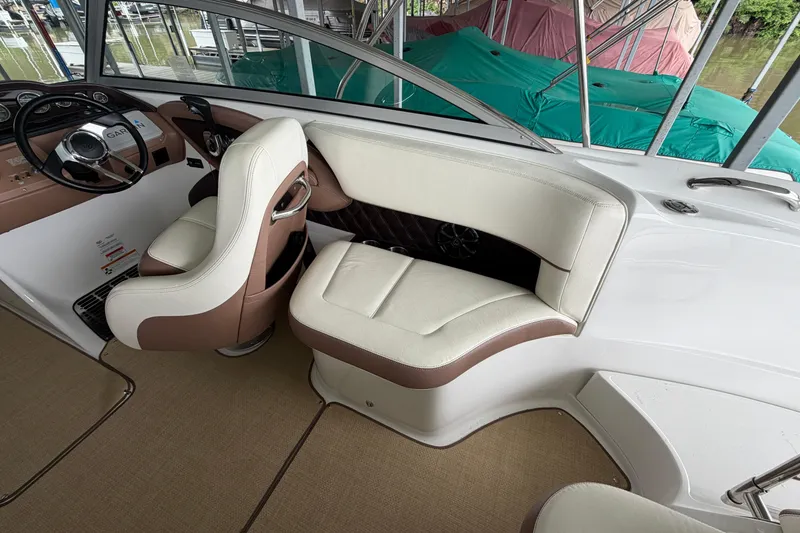 Slide: The Image of Interior of a 2012 Cobalt 242 boat with beige and brown seating. - 15