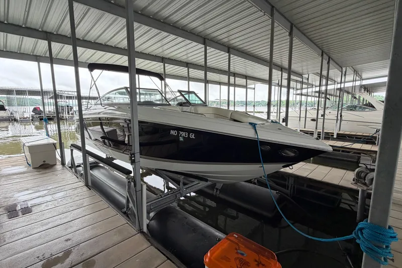 Slide: The Image of 2012 Cobalt 242 boat docked in a covered marina slip. - 2