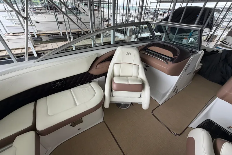 Slide: The Image of Interior of a 2012 Cobalt 242 boat with white and brown seating. - 20