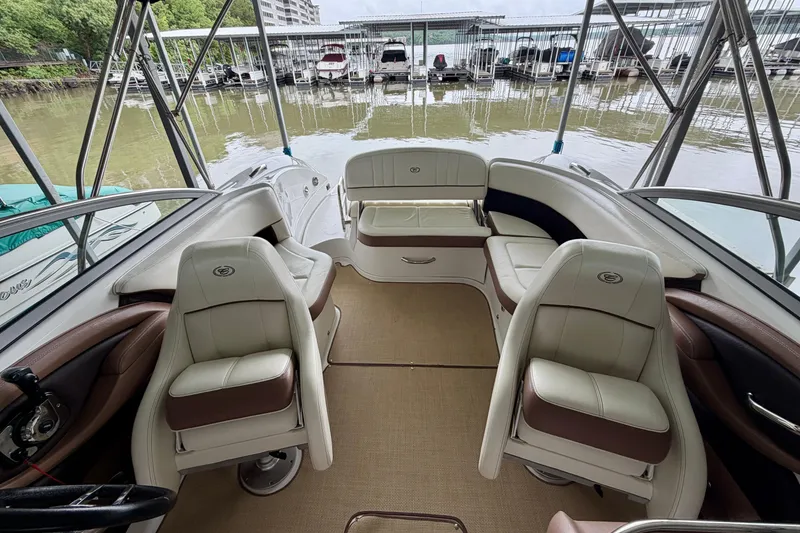 Slide: The Image of Interior of a 2012 Cobalt 242 boat with plush seating and waterfront view. - 21