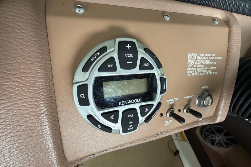 Slide: The Image of Kenwood audio control panel on 2012 Cobalt 242 boat dashboard. - 23