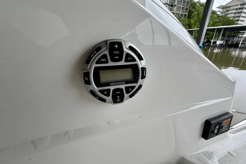 Slide: The Image of Kenwood audio control panel on a 2012 Cobalt 242 boat, dockside view. - 24