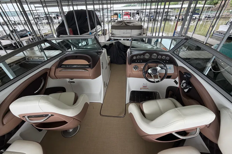 Slide: The Image of Interior of a 2012 Cobalt 242 boat with beige and brown seating. - 28