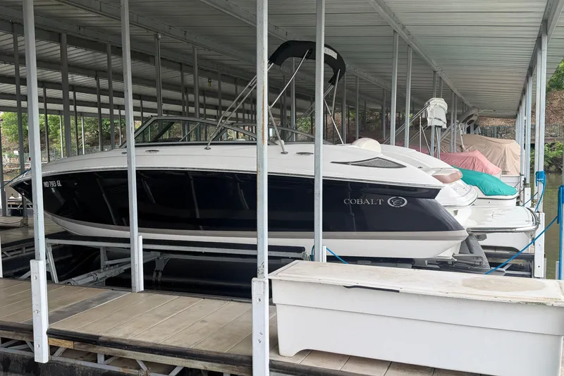 Slide: The Image of 2012 Cobalt 242 boat docked in a covered marina. - 3