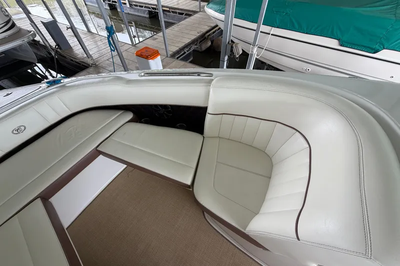 Slide: The Image of Interior of a 2012 Cobalt 242 boat with white leather seating. - 30