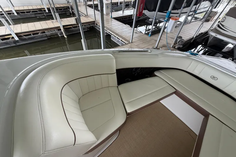 Slide: The Image of Interior of a 2012 Cobalt 242 boat with cream leather seating. - 31