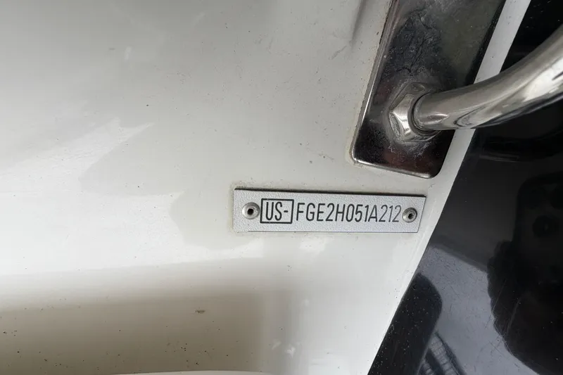 Slide: The Image of Hull identification number on a 2012 Cobalt 242 boat, displaying US-FGE2H051A212. - 36
