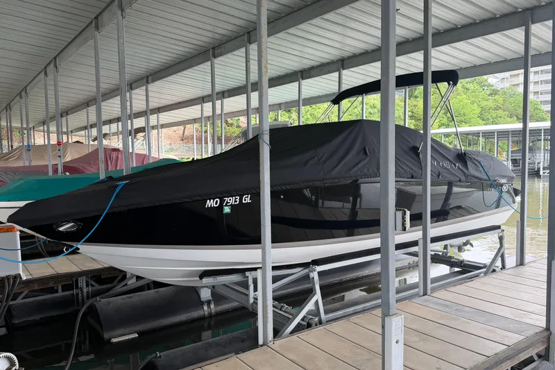 Slide: The Image of 2012 Cobalt 242 boat covered and docked in a marina. - 4