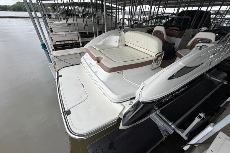 Slide: The Image of 2012 Cobalt 242 boat docked, featuring spacious seating and sleek design. - 7
