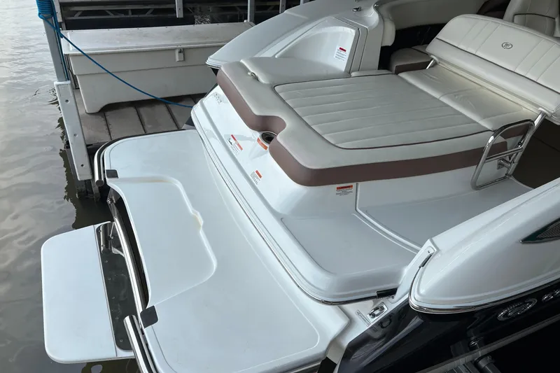 Slide: The Image of 2012 Cobalt 242 boat with swim platform and cushioned seating at dock. - 8